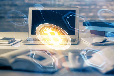 Multi exposure of blockchain theme hologram and table with computer background. Concept of bitcoin...