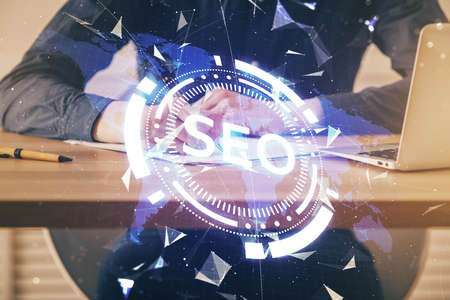 Mans hands with seo theme double exposure icon. Concept of search optimization.の写真素材