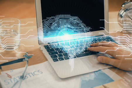 Man typing on keyboard background with brain hologram. Concept of big Data.