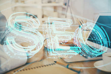 Double exposure of seo icon with man working on computer on background. Concept of search engine...