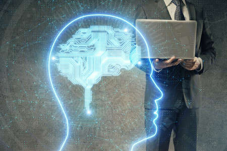 Businessman with computer background with brain theme hologram. Concept of brainstorm. Multi...