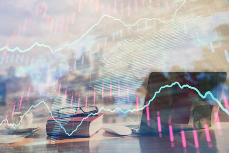 Double exposure of financial chart drawings and desk with open notebook background. Concept of forex...