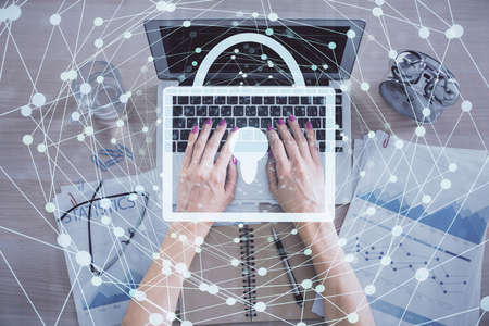 Double exposure of woman hands working on computer and lock hologram drawing. Top View. Security...