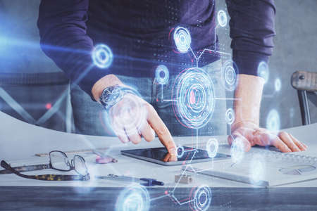 Double exposure of mans hand holding and using a digital device and data theme drawing. Technology...