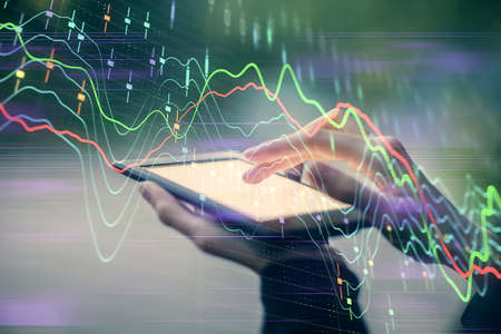 Double exposure of forex chart sketch hologram and woman holding and using a mobile device....