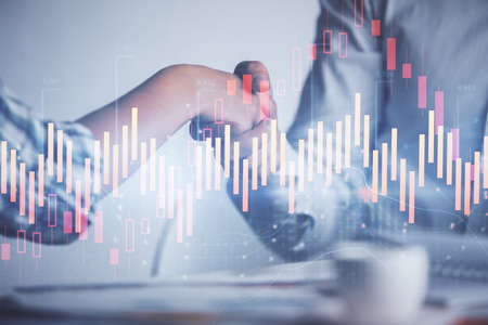 Double exposure of forex graph hologram and handshake of two men. Stock market concept.