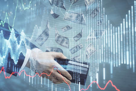 Multi exposure of financial graph drawing hologram and USA dollars bills and man hands. Analysis concept.の写真素材