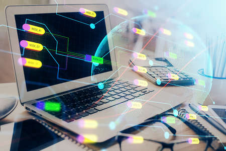 Double exposure of desktop with computer and world map hologram. International data network concept.の写真素材