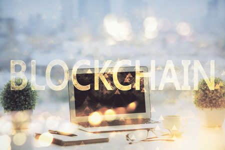 Double exposure of blockchain and crypto economy theme hologram and table with computer background....