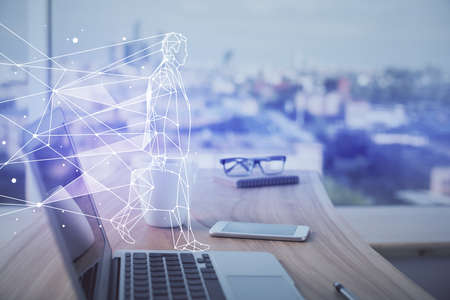 Desktop computer background in office and start up theme hologram drawing. Double exposure. Startup concept.の写真素材