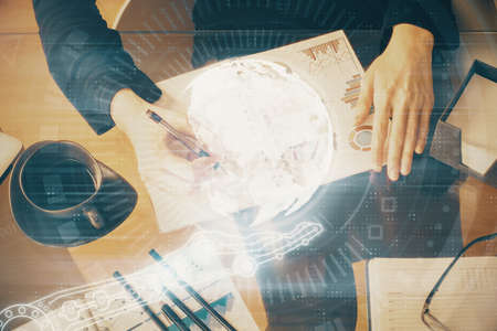 Multi exposure of hands making notes with world map hologram and data theme icons. Concept of global...