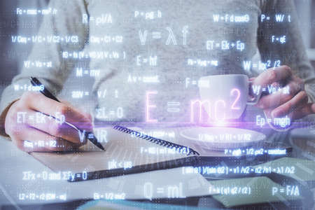 Science formula hologram over womans hands taking notes background. Concept of study. Double...
