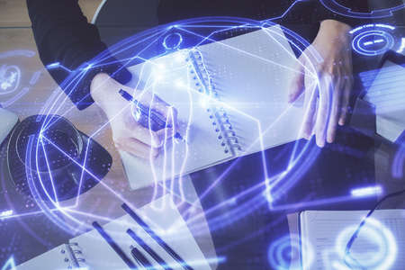 Education theme hologram over womans hands writing background. Concept of study. Double exposure