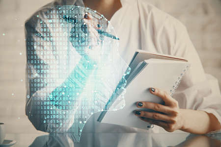 Multi exposure of writing hand on background with brain hologram. Concept of self learning.の写真素材