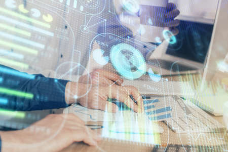 Double exposure of technology hologram with man working on computer background. Concept of big data.