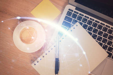 Social network hologram drawings over computer on the desktop background. Top view. Multi exposure. Concept of people connection.の写真素材
