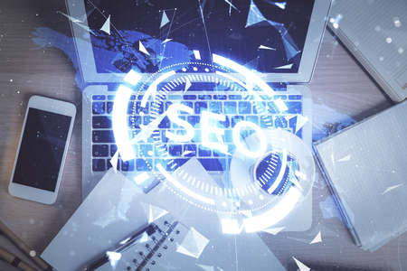 Double exposure of SEO drawing over study table background with computer. Concept of search. Top...