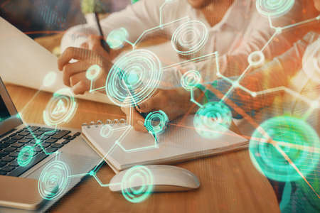 Double exposure of social network theme drawing over people taking notes background. Concept of...