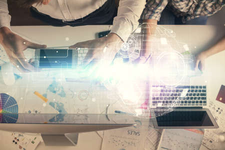Double exposure of man and woman working together and social network theme hologram drawing....