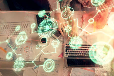 Double exposure of man and woman working together and social network theme hologram drawing....
