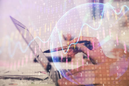 Multi exposure of woman hands typing on computer and financial graph hologram drawing. Stock market...
