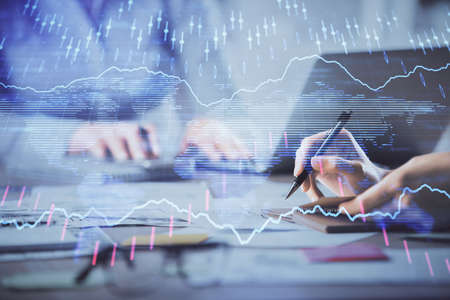 Multi exposure of woman hands typing on computer and financial chart hologram drawing. Stock market...