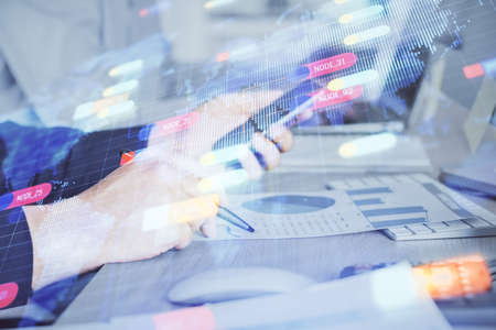 Double exposure of mans hand holding and using a digital device and data theme hologram drawing. Technology concept.の写真素材