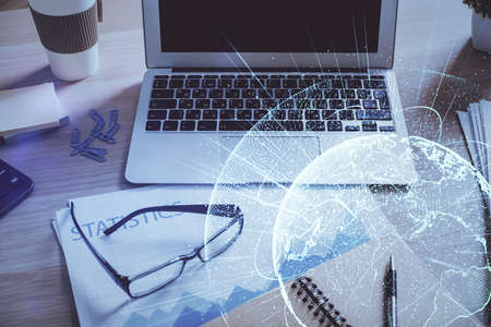 Computer on desktop with social network hologram. Double exposure. Concept of international people...