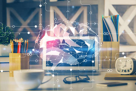 Double exposure of work space with computer and human brain drawing hologram. Brainstorm concept.