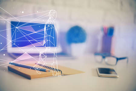 Desktop computer background in office and start up theme hologram drawing. Double exposure. Startup concept.の写真素材