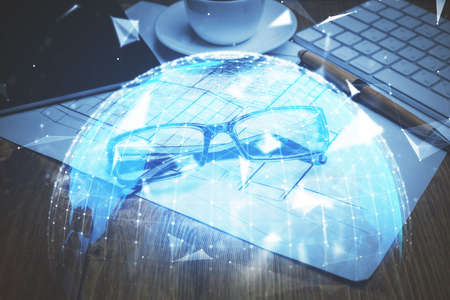 Business theme hologram with glasses on the table background. Concept of search. Double exposure.の写真素材