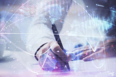 Double exposure of Man writing in notepad with business icons on background. Concept of international business.の写真素材
