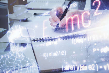 Science formula hologram over womans hands taking notes background. Concept of study. Multi exposureの写真素材