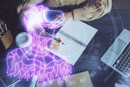 AR hologram over womans hands taking notes background. Concept of augmented reality. Multi exposure