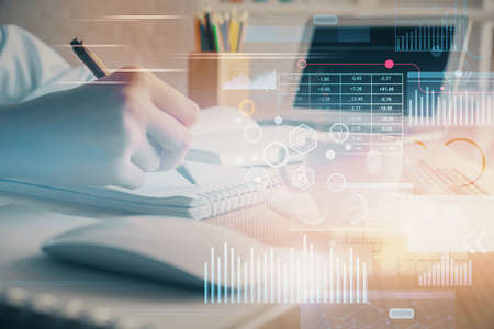 Double exposure of hands making notes with digital coding icons. Computer learning concept.