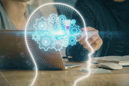 Businessman with computer background with brain theme hologram. Concept of brainstorm. Multi...