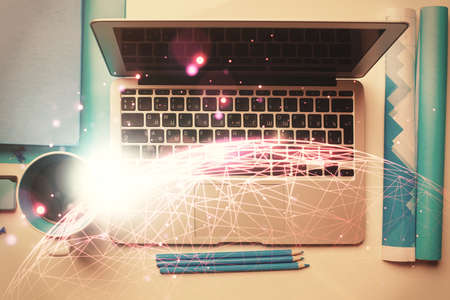 Social network hologram drawings over computer on the desktop background. Top view. Multi exposure. Concept of people connection.の写真素材