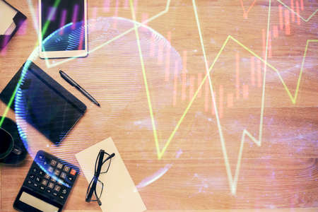 Double exposure of forex graph drawing and work table top veiw. Concept of financial analysis.