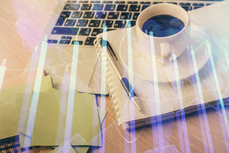 Double exposure of forex chart drawing and desktop with coffee and items on table background....