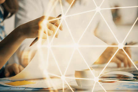 Double exposure of social network theme drawing over people taking notes background. Concept of human connectionの写真素材