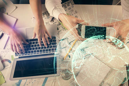 Double exposure of man and woman working together and social network theme hologram drawing....