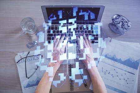 Double exposure of woman hands working on computer and data theme hologram drawing. Top View. Technology concept.の写真素材