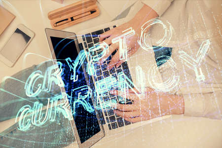 Double exposure of woman hands working on computer and blockchain theme hologram drawing. Top View. bitcoin cryptocurrency concept.の写真素材