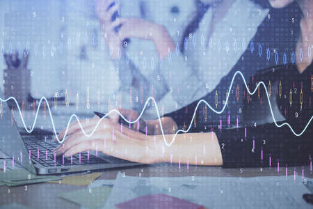 Multi exposure of woman hands typing on computer and financial graph hologram drawing. Stock market...