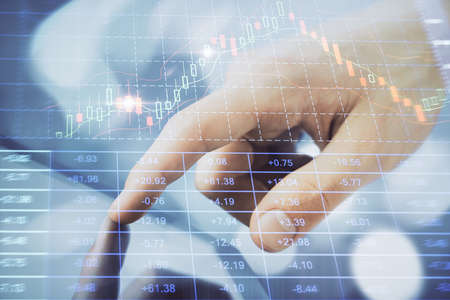 Multi exposure of mans hands holding and using a phone and financial chart drawing. Market analysis...