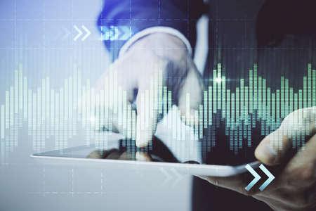 Multi exposure of mans hands holding and using a phone and financial chart drawing. Market analysis...