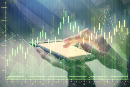 Double exposure of forex chart sketch hologram and woman holding and using a mobile device....