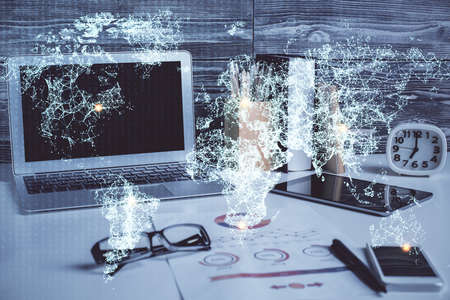 Computer on desktop with social network hologram. Double exposure. Concept of international people connections.の写真素材