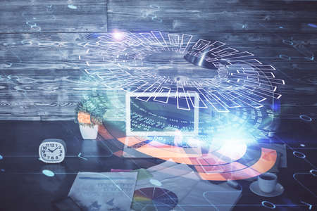 Double exposure of laptop computer and technology theme hologram. Concept of freelance work.