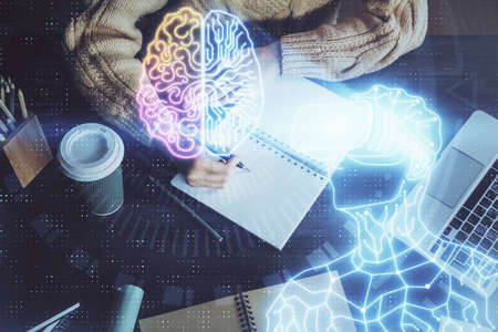 AR hologram over womans hands taking notes background. Concept of augmented reality. Multi exposureの写真素材